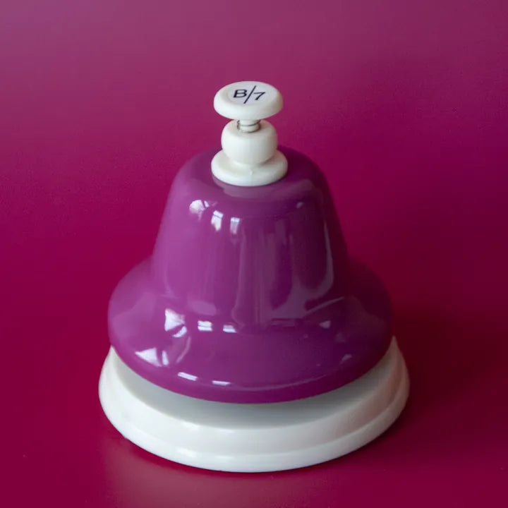 The purple B deskbell on a purple background