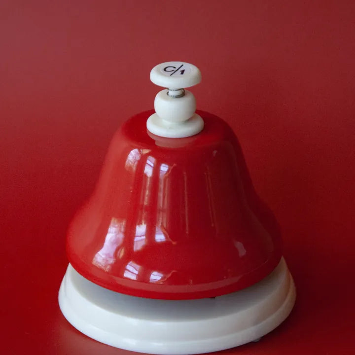 The red C deskbell on a red background
