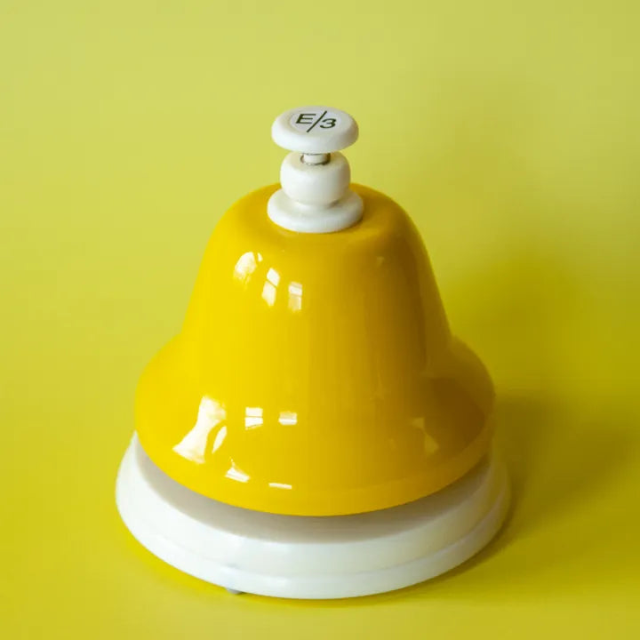 The yellow E deskbell on a yellow background