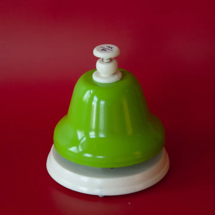 The green F deskbell on a red holiday background